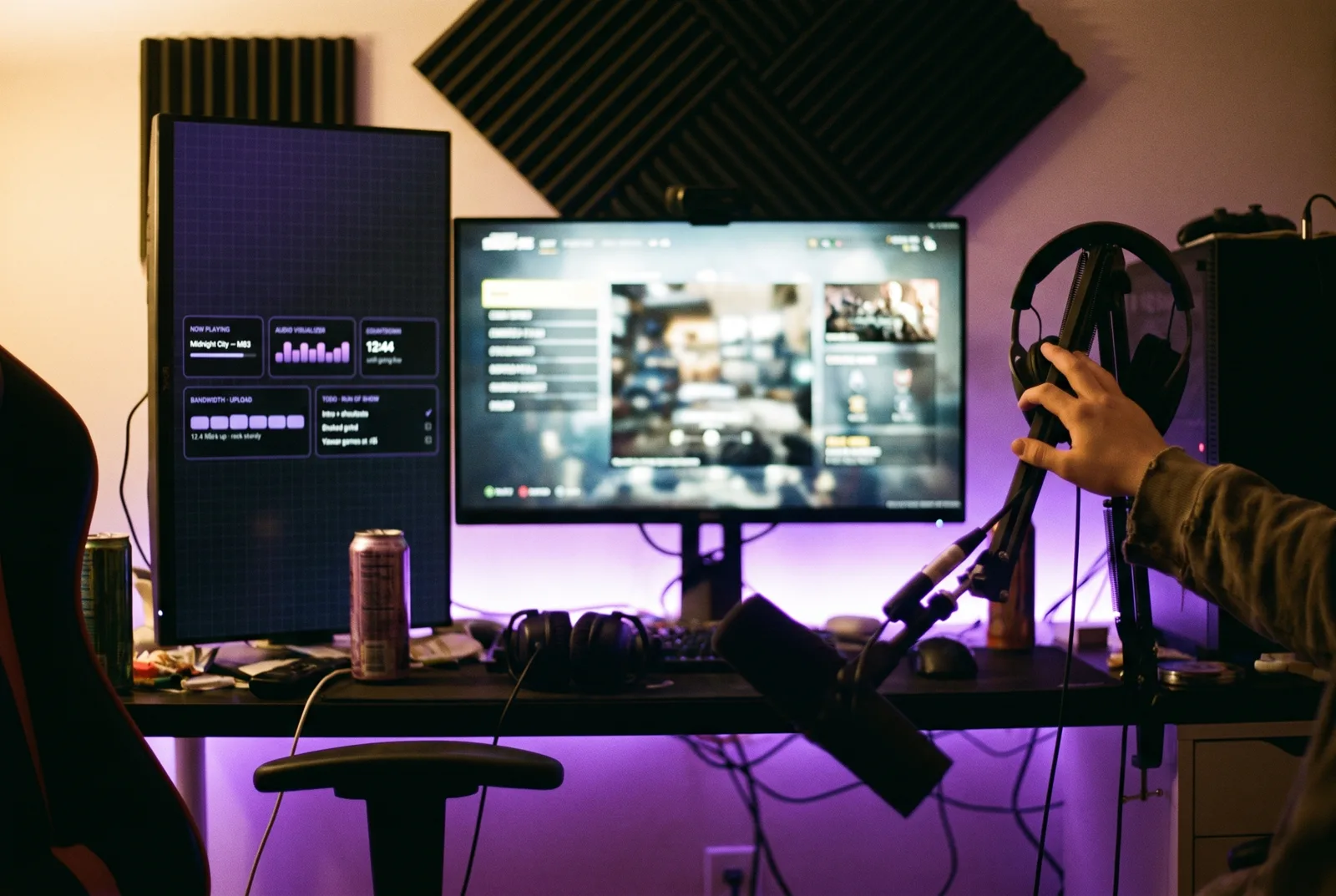 An RGB-lit streaming room with a side monitor showing a countdown to going live, music and upload bandwidth